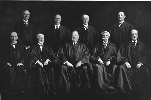 The White Court (1914-1916). Seated, from left to right: Justices William R. Day, Joseph McKenna, and Chief Justice Edward D. White, and Justices Oliver Wendell Holmes, Jr. and Charles Evans Hughes. Standing, from left to right: Mahlon Pitney, Willis Van Devanter, Joseph Rucker Lamar, James C. McReynolds.